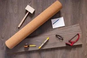 tools used for cork floor restoration including cork roll, sander tools and flooring planks in Australia